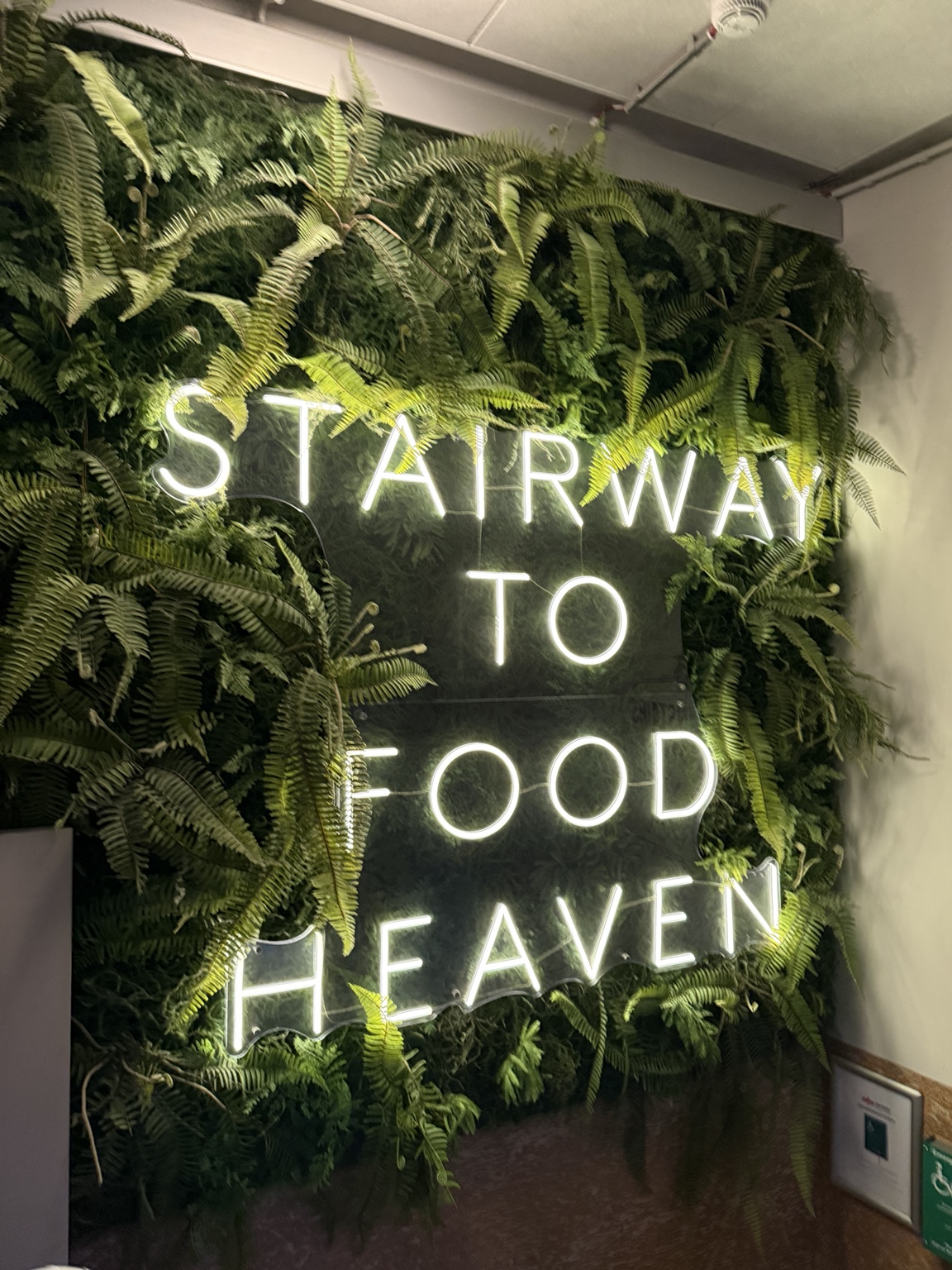 The illuminated Stairway to Food Heaven sign at Pósthús
